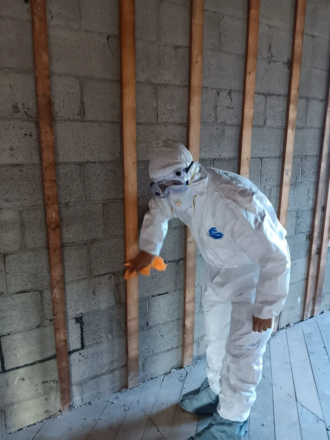 DryMaster technician in protective suit and respirator during fire cleanup