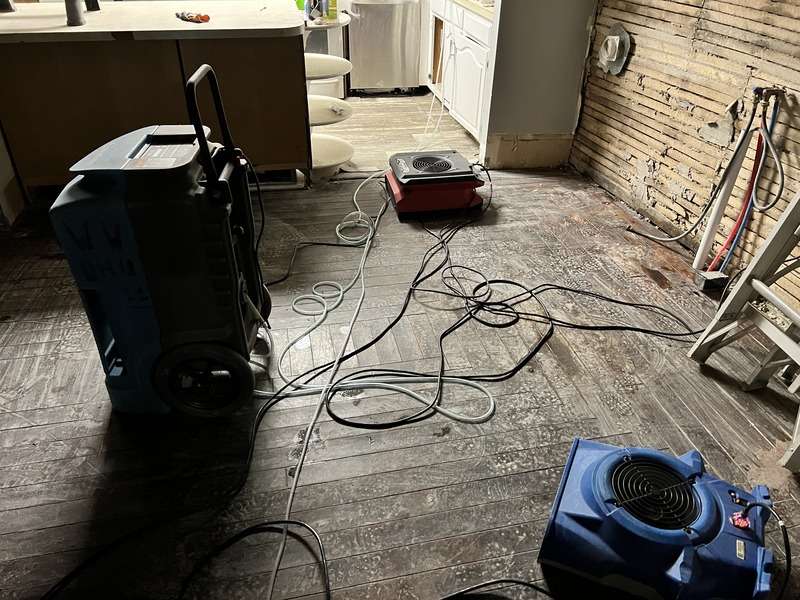 water damage restoration works continue in basement